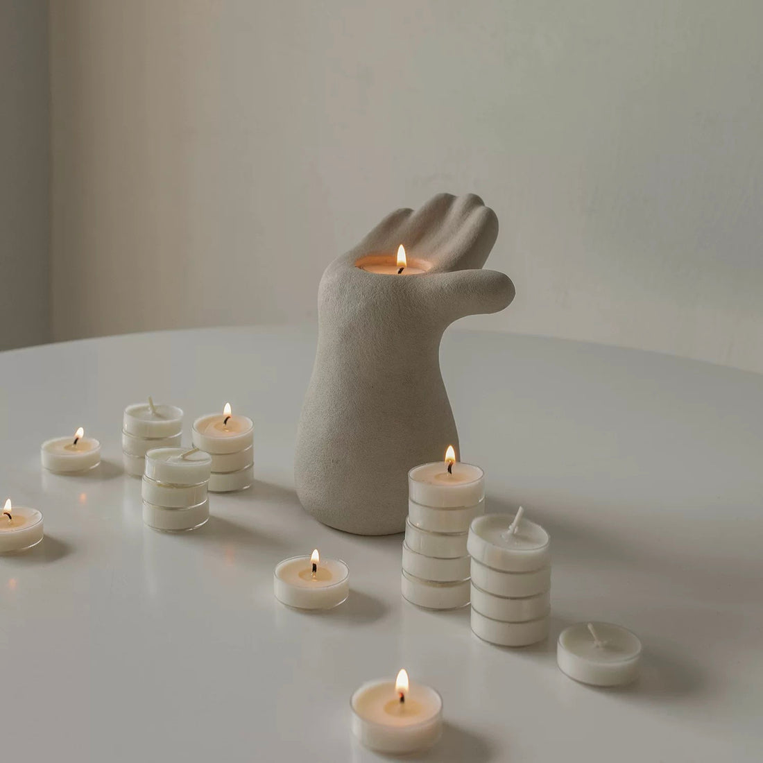 2025 candle holder trends, minimalist hand candle holder holding in the palm