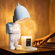 Astronaut Adjustable Heat Candle Warmer Lamp with Timer. Unique space-themed design with safe adjustable heat for even candle melting.