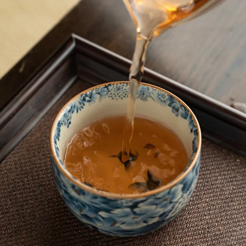 tea pouring in the Blue Lotus Ceramic Tea Cup, Elegant Teaware
