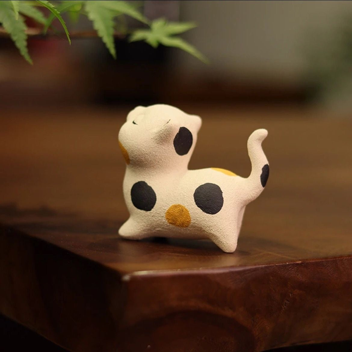 Cat-shaped Yixing purple clay tea pet featuring detailed craftsmanship, perfect for traditional tea ceremonies and collectors.