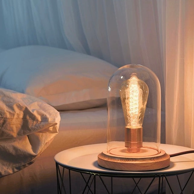 Lightbulb-shaped Transparent Glass Table Lamp. A sleek and modern table lamp in the shape of a lightbulb, perfect for adding an artistic and contemporary flair to your home decor.