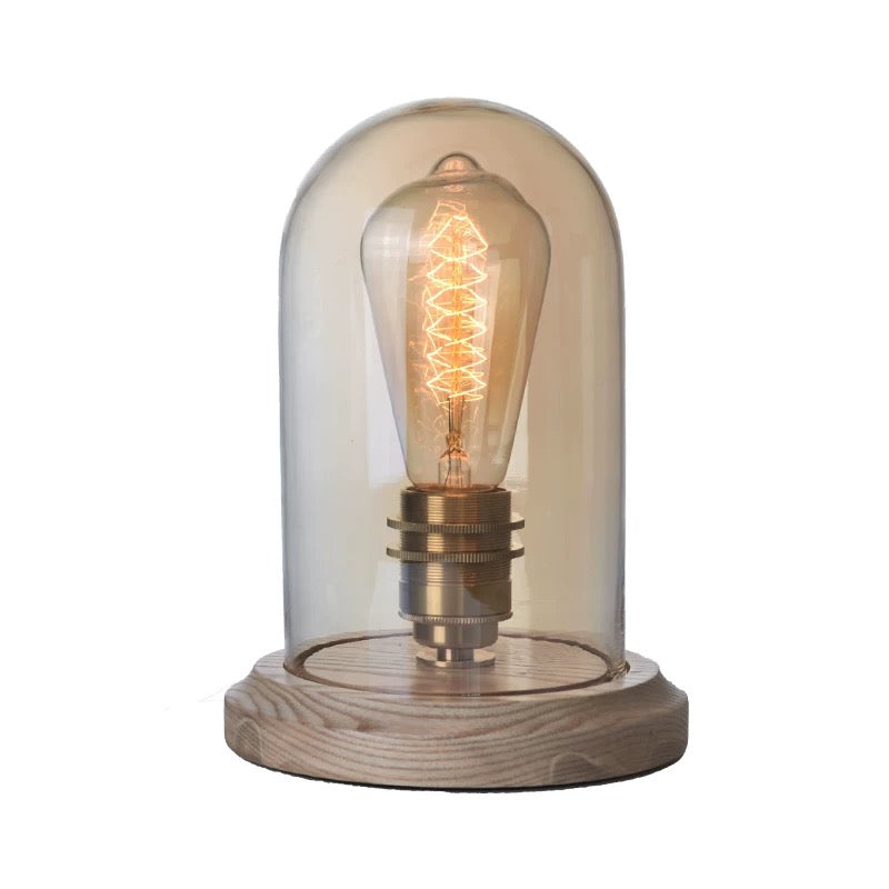 Lightbulb-shaped Transparent Glass Table Lamp. A sleek and modern table lamp in the shape of a lightbulb, perfect for adding an artistic and contemporary flair to your home decor.