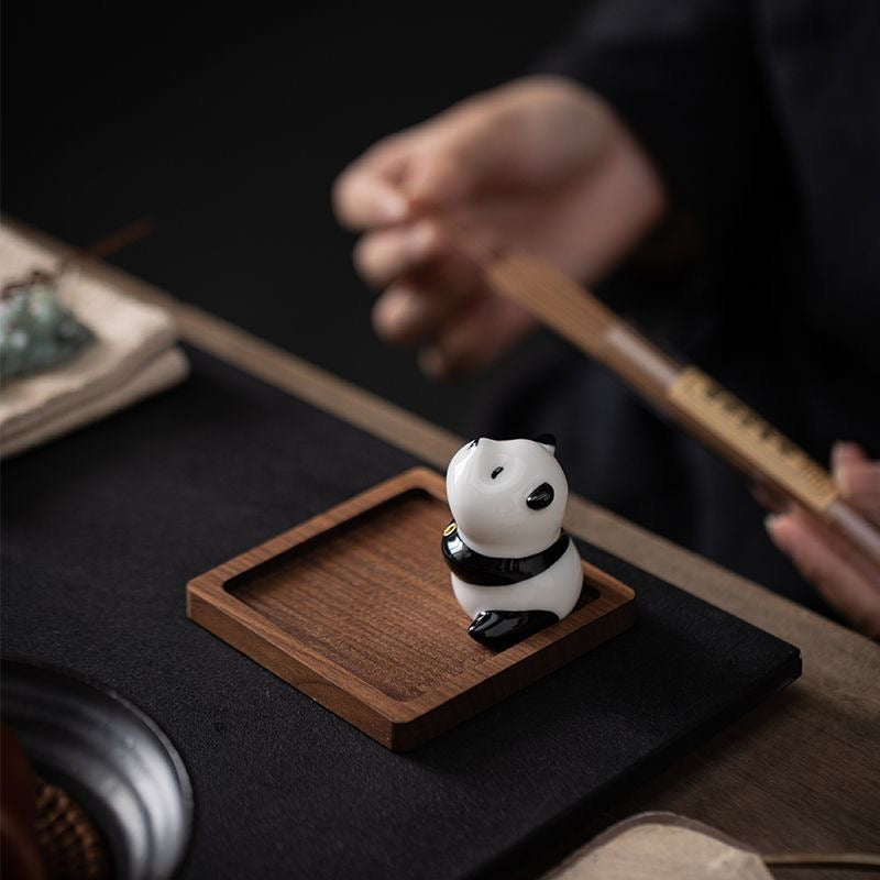 Panda-shaped ceramic incense holder featuring a playful design, ideal for home decor and meditation rituals.