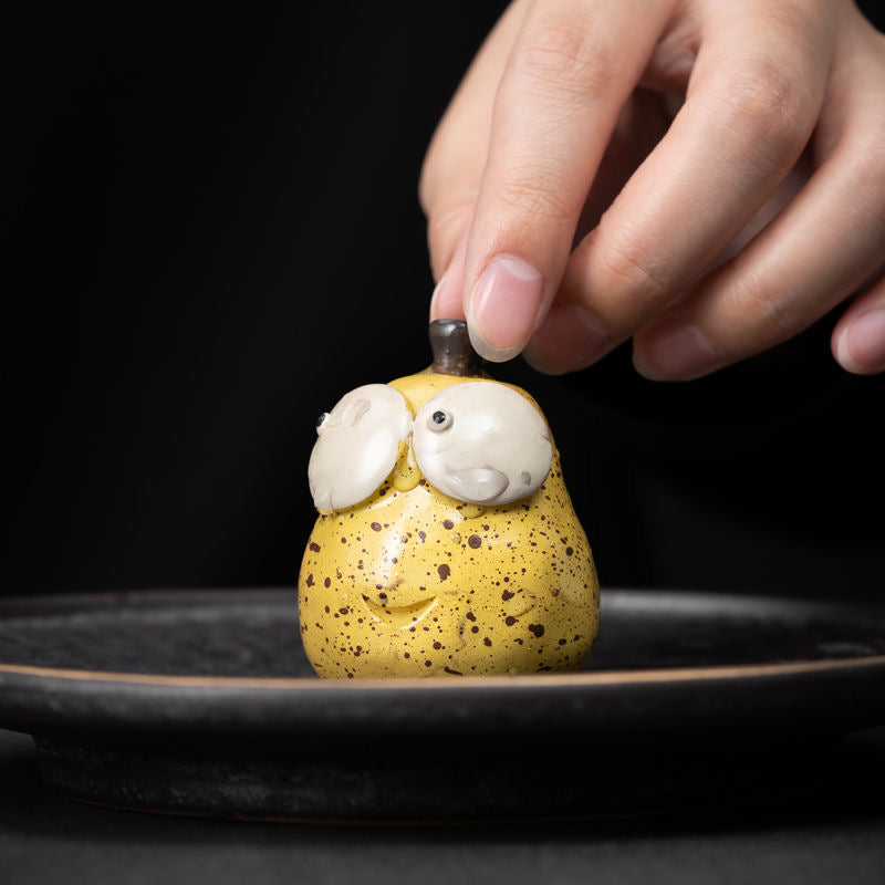 Pear Yixing Tea Pet. A beautifully crafted pear-shaped Yixing tea pet, perfect for enhancing your tea ceremony and bringing harmony to your tea rituals.
