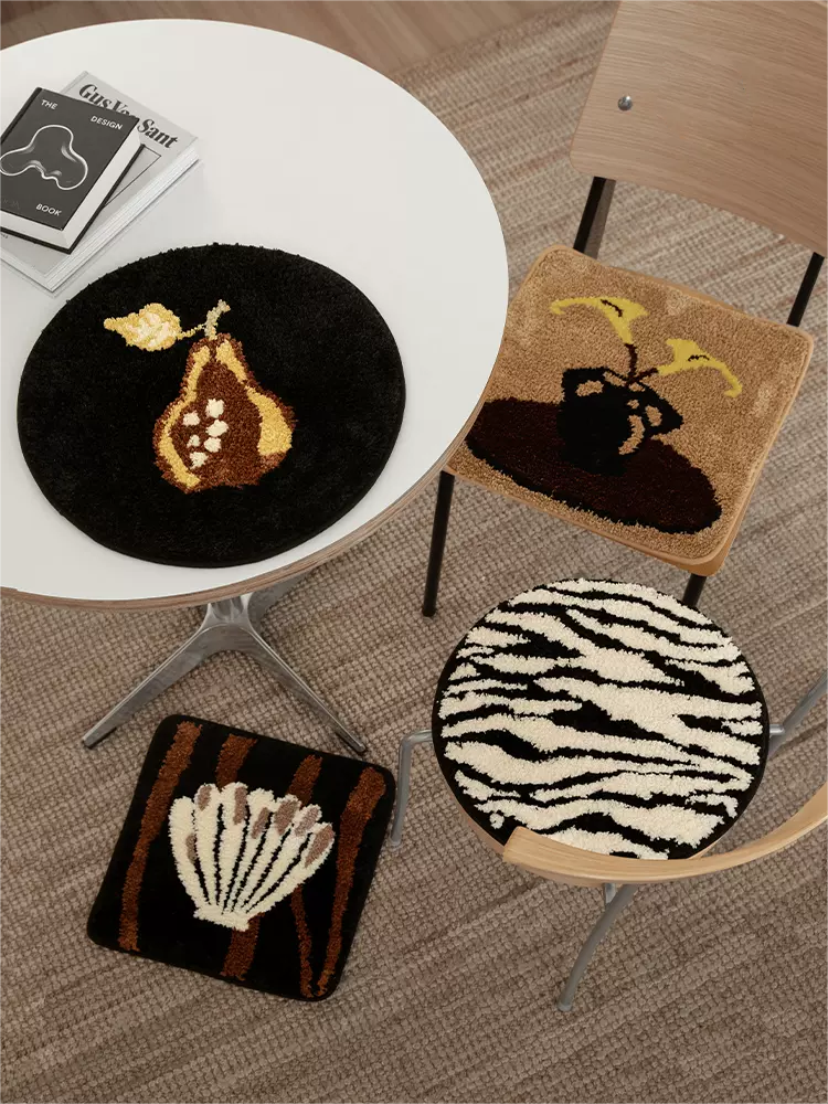 Set of 4 tufted rug and chair cushions in assorted styles, combining soft texture and versatile decor functionality.