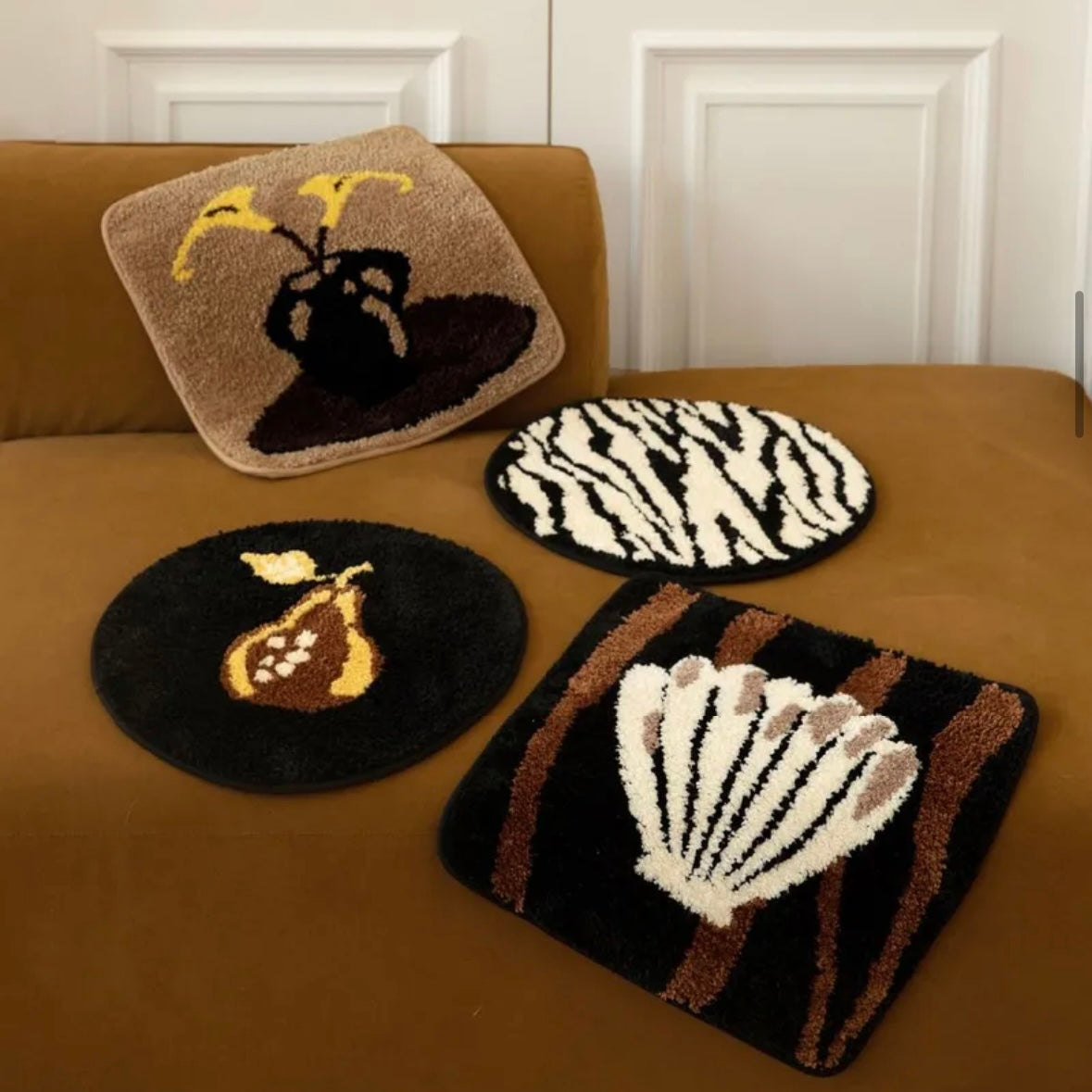 Set of 4 tufted rug and chair cushions in assorted styles, combining soft texture and versatile decor functionality.