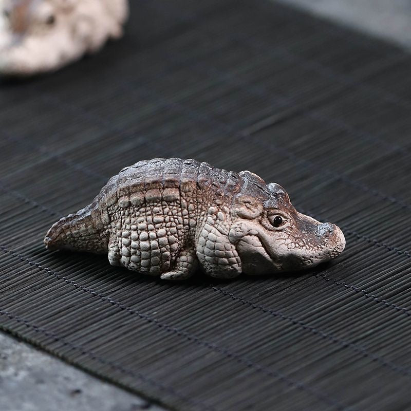 Handcrafted crocodile tea pet made of Yixing purple clay, combining detailed artistry and functionality for traditional tea ceremonies.