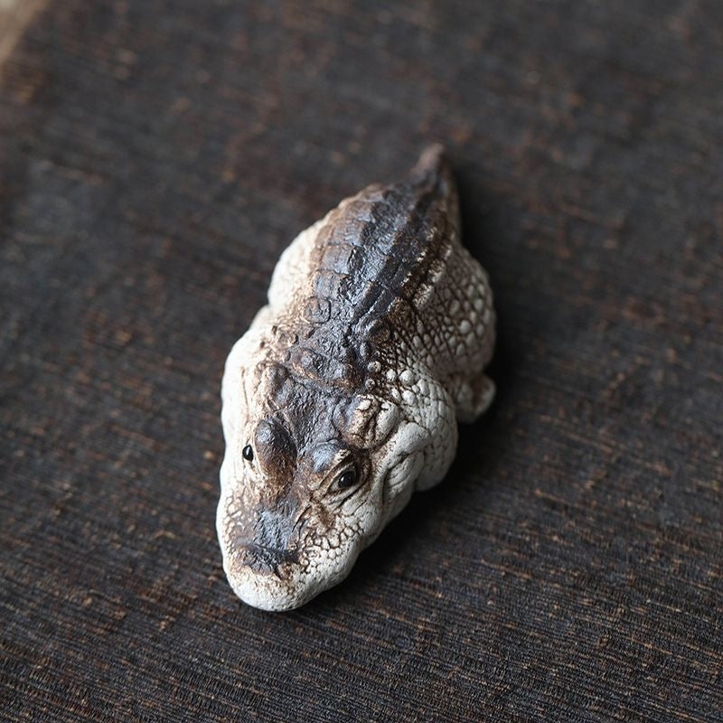 Handcrafted crocodile tea pet made of Yixing purple clay, combining detailed artistry and functionality for traditional tea ceremonies.