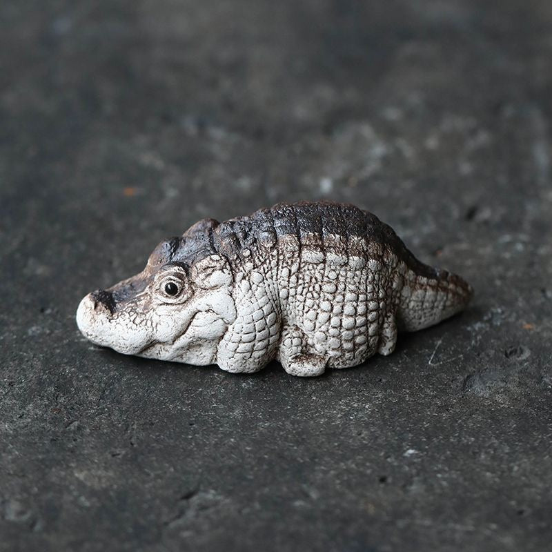 Handcrafted crocodile tea pet made of Yixing purple clay, combining detailed artistry and functionality for traditional tea ceremonies.