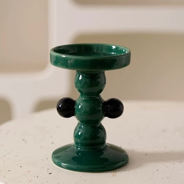 green ceramic modern candle holder with sleek and artistic design, ideal for contemporary home decor.