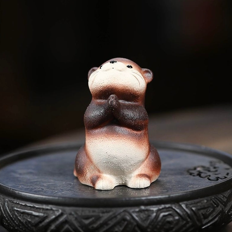 Handcrafted otter-shaped Yixing purple clay tea pet, designed for traditional tea ceremonies and collectors.