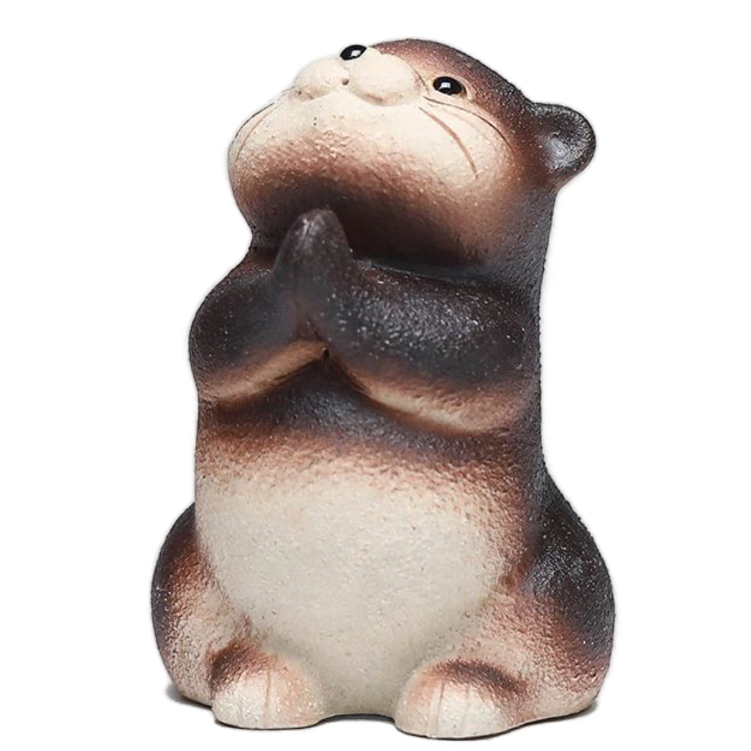 Handcrafted otter-shaped Yixing purple clay tea pet, designed for traditional tea ceremonies and collectors.