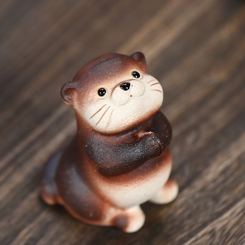 Handcrafted otter-shaped Yixing purple clay tea pet, designed for traditional tea ceremonies and collectors.